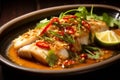 Thai dish of pla kapong neung manao, or steamed sea bass with lime sauce. The delicate sea bass is steamed is then bathed in a Royalty Free Stock Photo