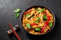 Thai Drunken Noodles or Pad Kee Mao in white plate at black slate background. Drunken Noodles is thai cuisine dish Royalty Free Stock Photo