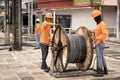 Thai electrician workers unwrap a bay with a cable on the street. Laying of new power grids of cables and wiring. Thailand, Khao