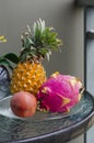 Thai exotic fruits pineapple, dragonfruit, passion fruit on a glass table