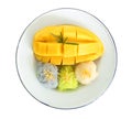 Thai famous dessert - Top view of sweet fresh ripe mango with three color of sticky rice , green from pandan and purple from Royalty Free Stock Photo