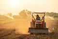 Thai farmer on big tractor in the land to prepare the soil