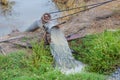 Thai farming methods - Pumping water from the canal to rice fields, Engine, baler from the canal into rice field, The water is