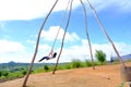 Thai female was playing wooden the swings at Khao Kho, Phetchabun, Thailand