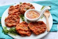 Thai fish cake or Tod Mun Pla served with sweet chili sauce at close up view in a white plate Royalty Free Stock Photo