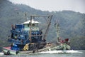 Thai fisher people sailing fishing boat ship in sea after catch fish and marine life in ocean of Phetra National Park to