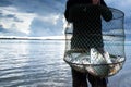 Thai fisherman holding a shoal of big Common Silver barb in a fish net Royalty Free Stock Photo