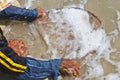 A thai fisherman is searching for shells (Pharella javanica) Royalty Free Stock Photo