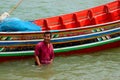 A Thai fisherman stands in water by his boat Pattani Thailand