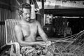 Thai fishermen mending his fishing net in Thailand