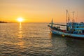 A fishing boat at a pier in the early evening during sunset time Royalty Free Stock Photo