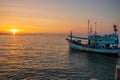 A fishing boat at a pier in the early evening during sunset time Royalty Free Stock Photo