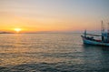 A fishing boat at a pier in the early evening during sunset time Royalty Free Stock Photo