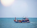 Thai fishing boat traditional used as a vehicle for finding fish in the sea at sunset.