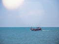 Thai fishing boat traditional used as a vehicle for finding fish in the sea at sunset. Royalty Free Stock Photo