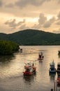 Thai fishing boats are sailing out to sea in the evening at sunset Royalty Free Stock Photo