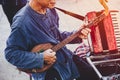 Thai folklore musician playing folk song with Pin Isan Guitar