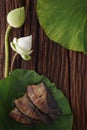 Thai food dried salted damsel fish fried with flower lotus jasmine decoration on wooden background beautiful flat lay still life r