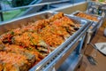 A Thai food fish stir fried in a spicy sauce in aluminum triangle plate on line buffet in front of seminar room