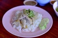 Thai food. Hainanese chicken rice on wood table background. Steamed chicken rice with spicy sauces and chicken soup Royalty Free Stock Photo