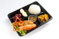 Thai food lunch box in plastic packages, Rice with fried shrimp and red chicken curry Royalty Free Stock Photo