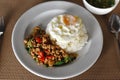 Thai Food, Rice topped stir-fried chicken and basil with Fried egg on white plate. is popular menu of Thailand street food that Royalty Free Stock Photo