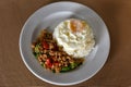 Thai Food, Rice topped stir-fried chicken and basil with Fried egg on white plate. is popular menu of Thailand street food that Royalty Free Stock Photo