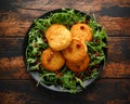 Thai food spicy fish cakes served with pomegranate seeds and wild rocket, arugula salad. Royalty Free Stock Photo