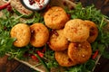 Thai food spicy fish cakes served with pomegranate seeds and wild rocket, arugula salad. Royalty Free Stock Photo