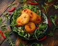 Thai food spicy fish cakes served with pomegranate seeds and wild rocket, arugula salad. Royalty Free Stock Photo