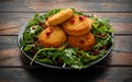 Thai food spicy fish cakes served with pomegranate seeds and wild rocket, arugula salad. Royalty Free Stock Photo