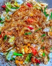 Thai food stir-fried vermicelli with eggs, onions, spring onions, bell peppers, lettuce and tomatoes Royalty Free Stock Photo