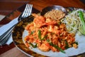 Thai food, stir fry rice noodles with shrimps, tofu, vegetable and crushed peanuts or pad thai on wooden table background Royalty Free Stock Photo