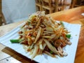 Thai food style, Close up of papaya salad with tomato, shrimp, chili, bean, morning glory and cabbage on white plate on wooden. Royalty Free Stock Photo