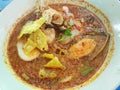 Thai food style,Top view of noodle with squid, boiled egg, mussel, shrimp, hot and Sour Soup in white bowl.