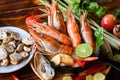 Thai Food Tom Yum Kung, Hot and sour spicy shrimps prawns soup curry lemon lime galangal red chili straw mushroom on table food, Royalty Free Stock Photo