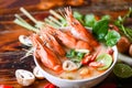 Thai Food Tom Yum Kung, Hot and sour spicy shrimps prawns soup curry lemon lime galangal red chili straw mushroom on table food, Royalty Free Stock Photo