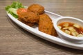 Thai Fried Fish-Paste Balls, Thai Style Fish Cake served with Thai cucumber salad. Royalty Free Stock Photo