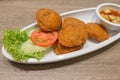 Thai Fried Fish-Paste Balls, Thai Style Fish Cake served with Thai cucumber salad. Royalty Free Stock Photo