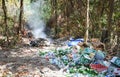 Thai garbage recycle pile plastic bottle and glass bottle in the nature with incineration waste burning cause air pollution or
