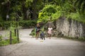 Thai girl and sisters people walking relax and biking bicycle on street at Baan Huay Nam Sai rural countryside village valley hill