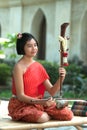 Thai girl in traditional dress in playing Thai fiddle.