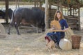 Thai girl winnowing rice separate between rice and rice husk on farm background