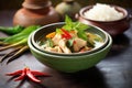 thai green curry with chicken in a ceramic bowl