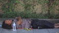 Thai homeless male sleeping on footpath