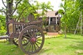 Thai house style and Old farmer wooden cart. Royalty Free Stock Photo