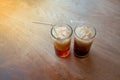 Thai ice tea and ice coffee with white straw in clear glass on w Royalty Free Stock Photo