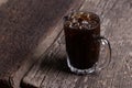 Thai iced black coffee signature local beverage on wooden background called oliang