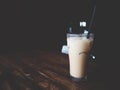 This is Thai iced tea in the glass above wooden desk, soft tone