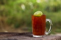 Thai iced tea with lime lemon signature local beverage on wooden Royalty Free Stock Photo